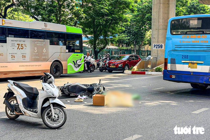 Xe máy của nạn nhân đổ trên đường Xuân Thủy sau vụ tai nạn liên hoàn